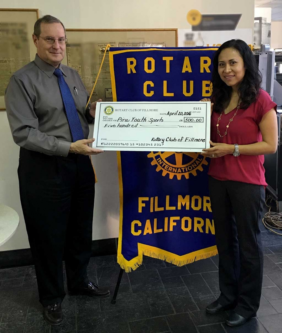 Rotary supports Piru Youth Sports. Rotary President Kyle Wilson, presented a donation to Lupe Hurtado for Piru Youth Sports.