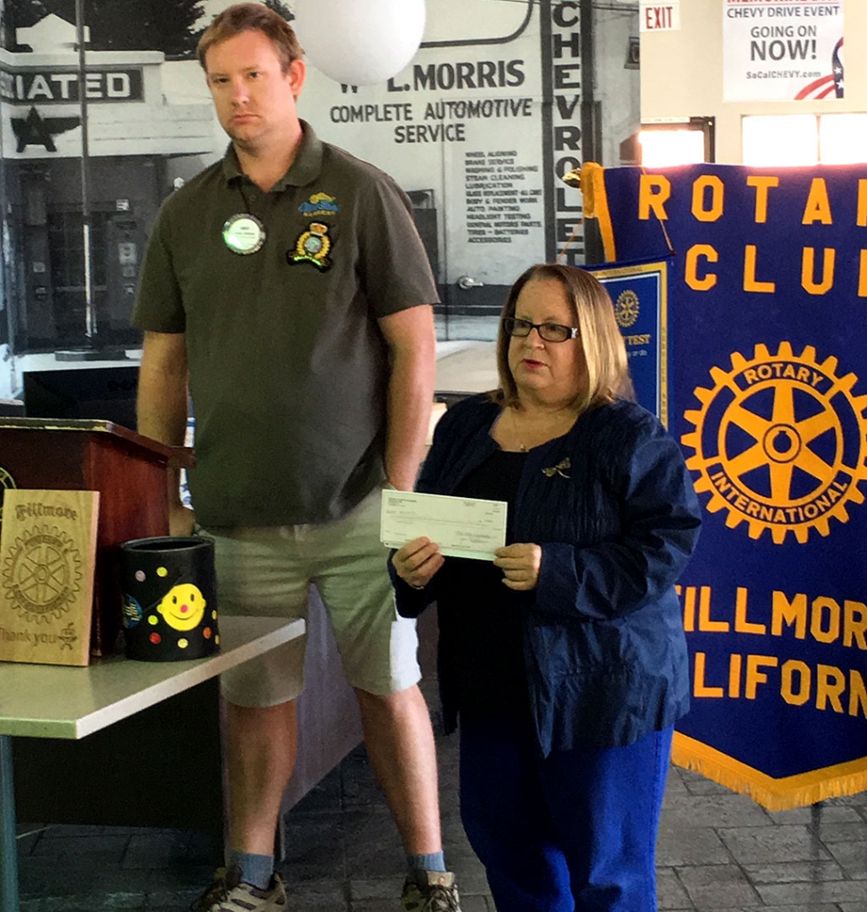 Fillmore Rotary Club donated $1,000 to the Boys & Girls Club Summer Camp. Pictured is Rotary President Andy Klittich presenting Jan Marholin of the Boys & Girls Club, who expressed her thanks and related what the camp means to the students. Photo courtesy Martha Richardson.