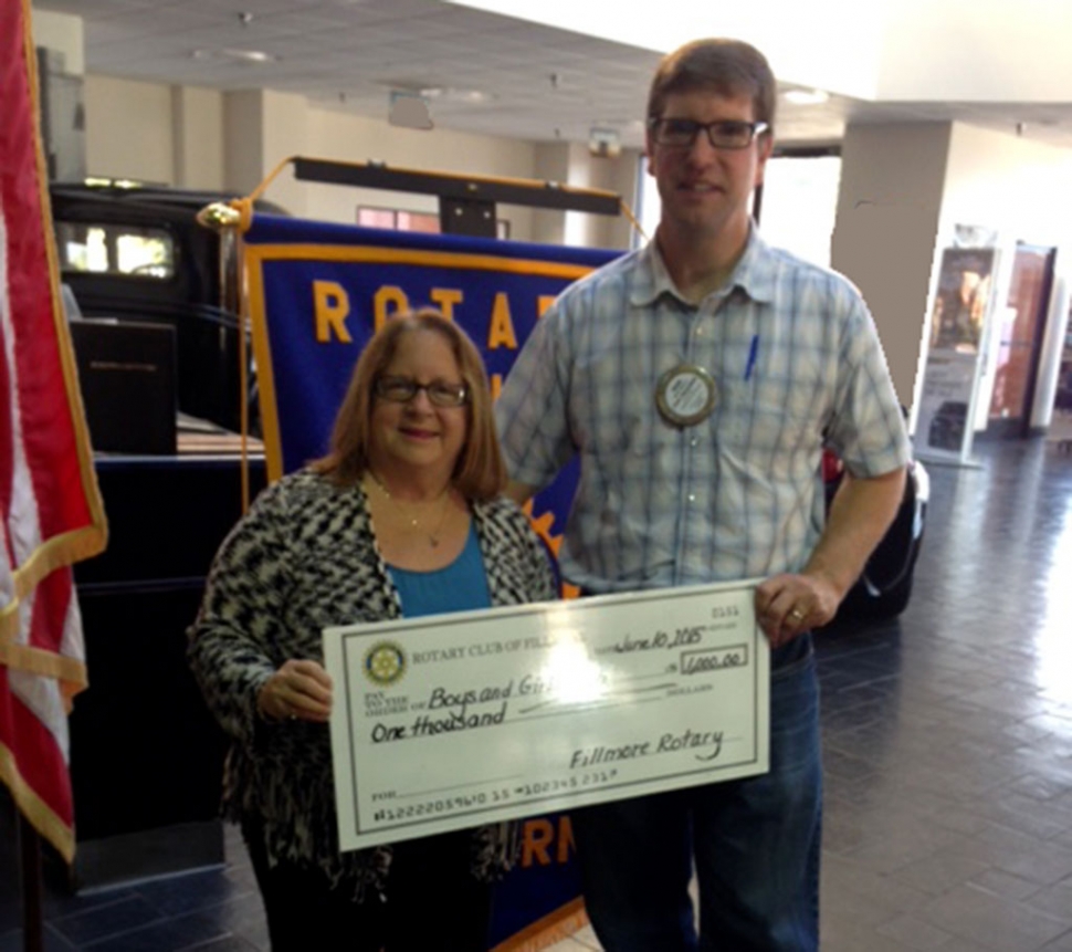 Rotary benefits Boys & Girls Club. Jan Marholin accepts a check from Sean Morris, President of Fillmore Rotary, for the Boys & Girls Club Kids Fun Day at the Club event in July.
