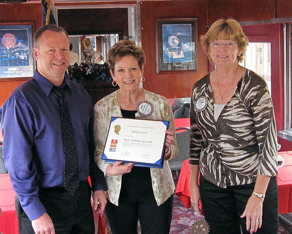 Darryl Smith, husband of Barbara Smith, center, who was awarded the Paul Harris Award, Martha Richardson, President.