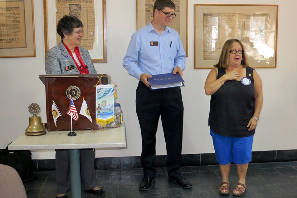 Jan Marholin was surprised by Loretta Butts and Sean Morris as they presented her a Paul Harris Award.