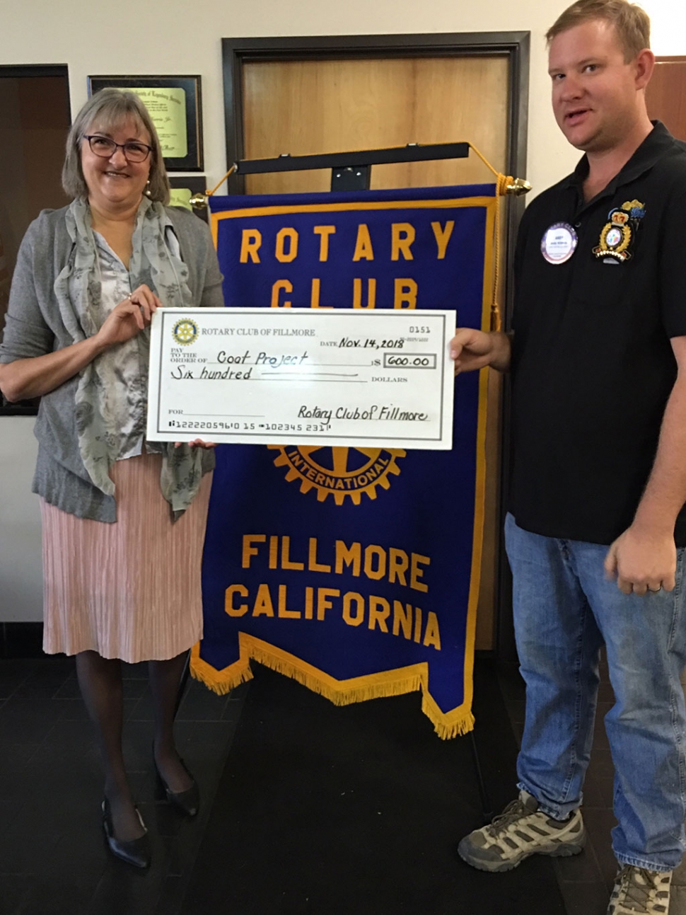 Laura Bartels received a check for $600 on behalf of Santa Clara Valley Legal Aid. Rotary President Andy Klittich presented the check which is used to buy warm winter coats for children in need. Bartels has been hosting the fundraiser for 10 years. Photo courtesy Martha Richardson & Ari Larson.