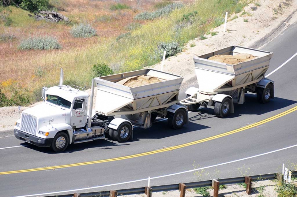 Highway 23 from near the top of Grimes Canyon, four cars begin to stack-up behind a double belly-dump truck exiting the sand quarry. The cities of Malibu and Moorpark are trying to add 400 more trucks per day to Malibu through Fillmore for 10-years.