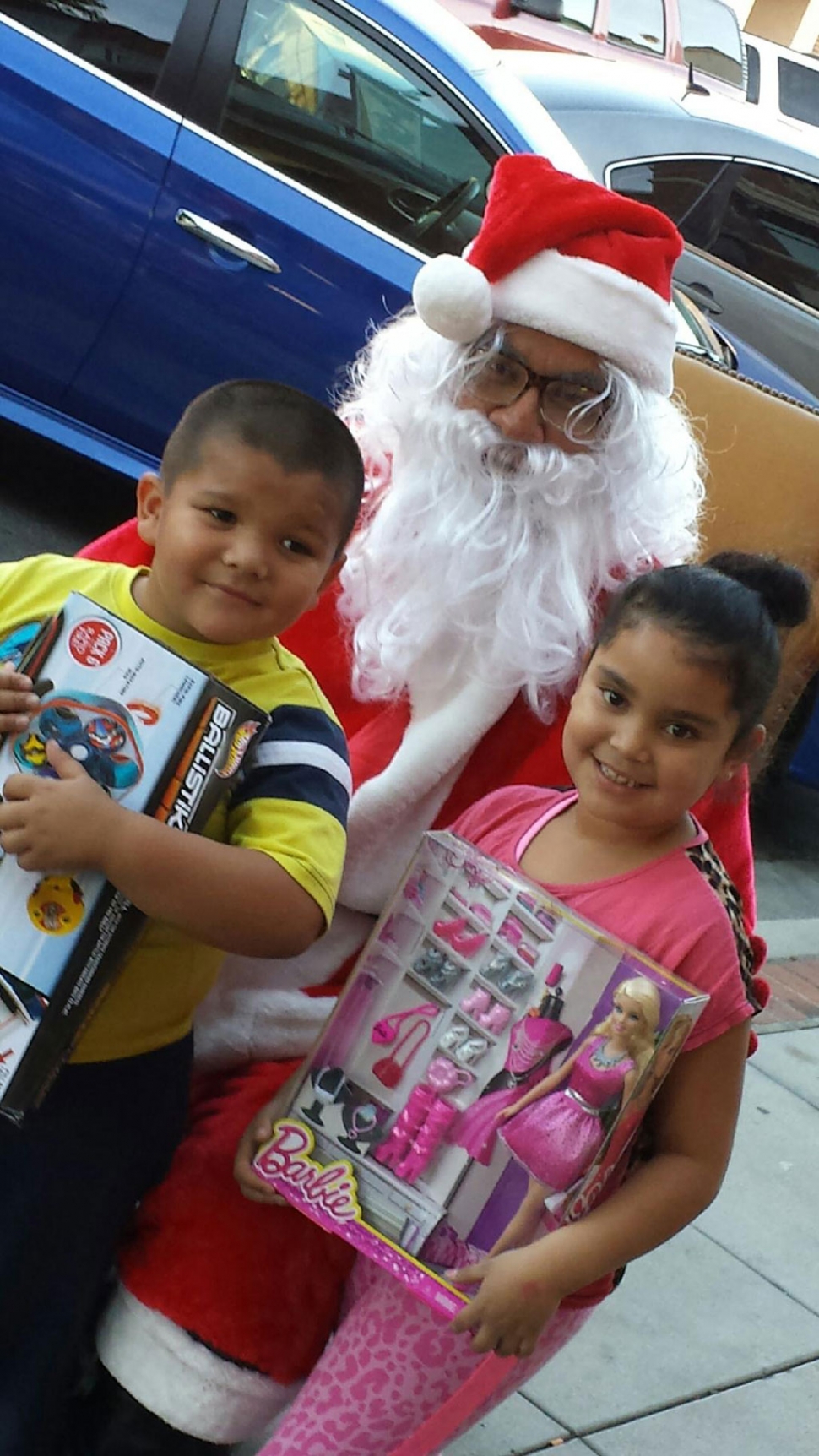 Santa really gets around! He visited the Clinicas on Central Avenue. Siblings Junior and Maria were happy to see him in town.