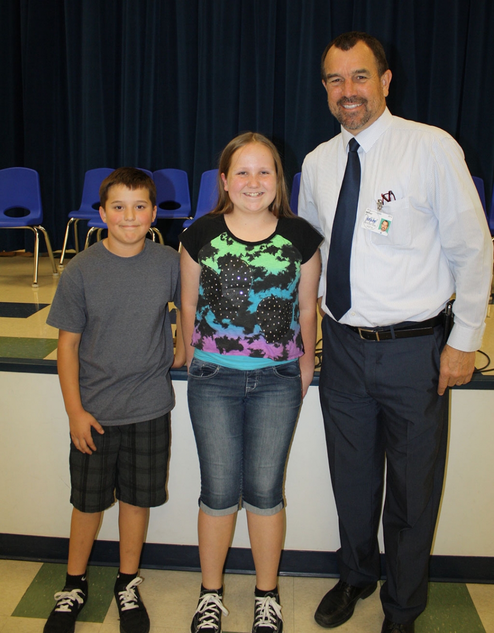 (l-r) Runner-up Phillip Cervantes, Champion Emma Myers, with MV Principal John Wilber. The audience was on the edge of their seats as 28 students competed last week to earn the title of Mountain Vista School Spelling Bee Champion.  Competition was intense between the 3rd, 4th, and 5th graders through five rounds. Finally, after eight rounds Emma Myers won with the championship word “full-fledged.”  Phillip Cervantes is runner-up.  The next stage in the competition is the Ventura County Bee held March 7 at California State Channel Islands University.