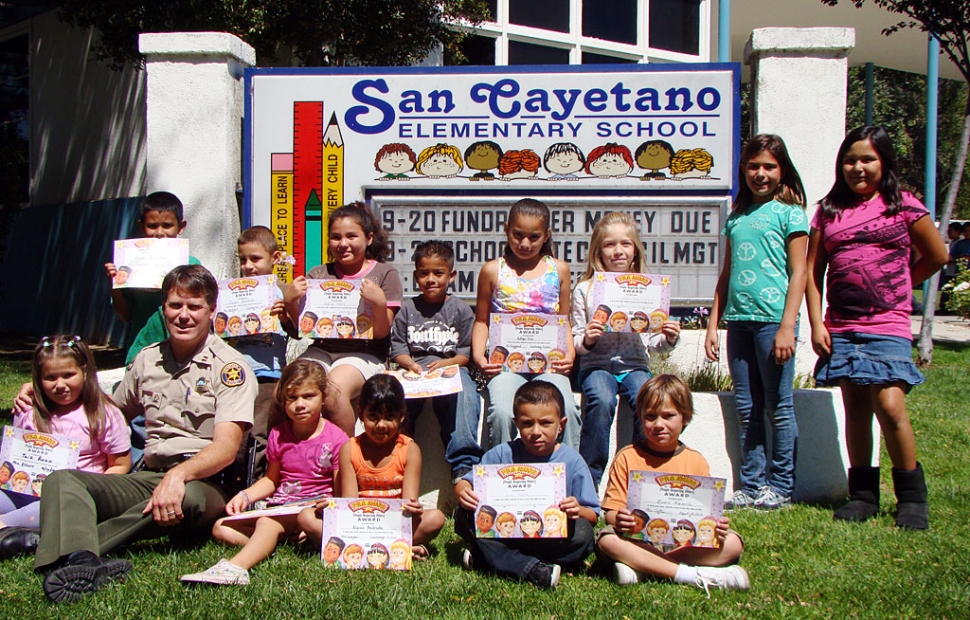 Capt. Tim Hagel is shown with Peacebuilders of the month.