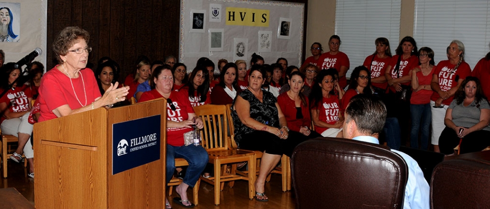 At last Tuesday’s school board meeting the room was filled with a sea of red shirts in support of Fillmore Unified teachers and their fight for fair wages. Pictured is retired FUSD teacher Mary Ford voicing the FUTA’s concerns.
