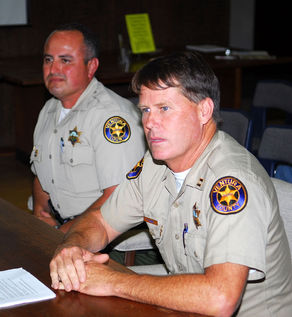 Left, Deputy Leo Vazquez with Captain Tim Hagel (right) review the benefits of the SRO during Tuesday night’s meeting.