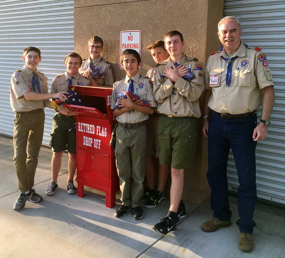 Boy Scouts from Troop 406: James Chandler, Matt Van de Mheen, Jared Fairall, Jr. Escoto, Timmy Vargas, Matt Henschel, and Brett Chandler, Scoutmaster, are shown emptying the flag retirement drop box.