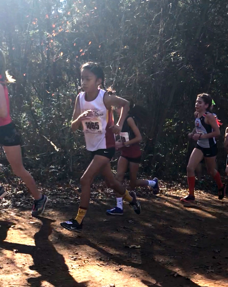 Pictured out in front is Emily Arriaga running up the hill in the 3000 meters girls 9 and 10-year-old race where she earned the “All-American” award. Photos courtesy Coach Evelio Arriaga.
