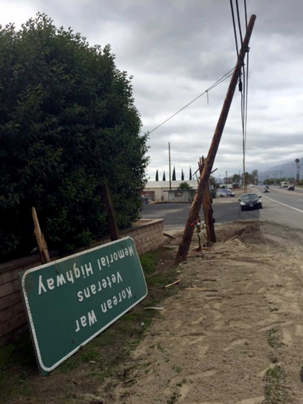 The Korean War Veterans Memorial Highway sign was sheared off along with a telephone pole by a truck pulling a utility trailer.