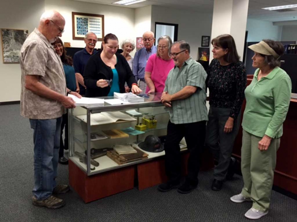 S.O.A.R. volunteers Bob and Joann Stroh, Jamey and Lynne Brooks, Donna Cruz, Jerry Donckels, Clay and Jean Westling, and Jo Ann Wernock, watching Impeartrice stamp the petitions.