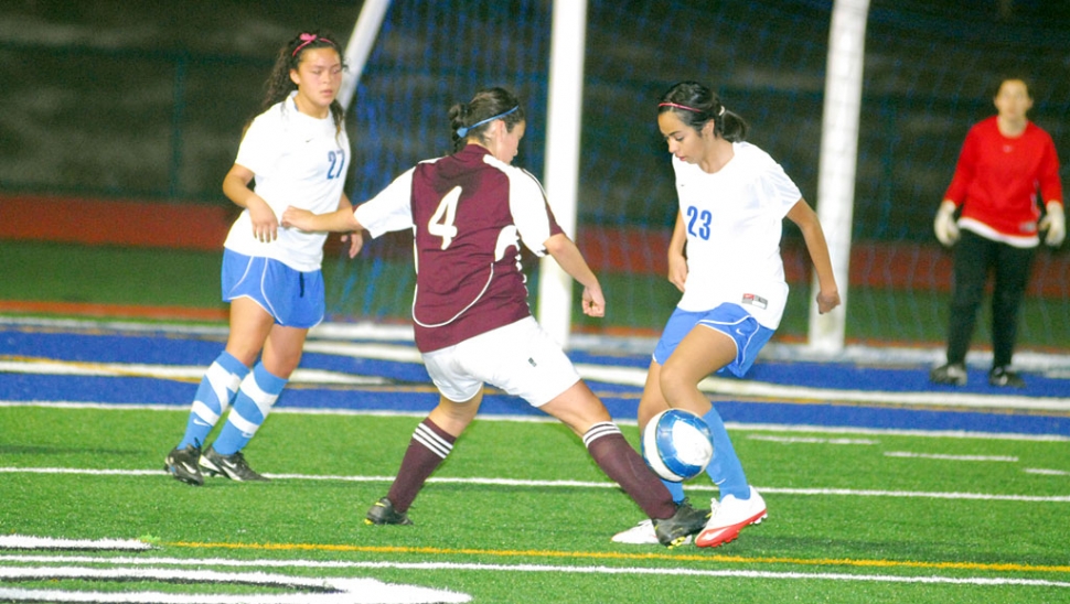 Alexis Beccera #23 and Jasmine Medina work together to keep the ball away from the goal.
