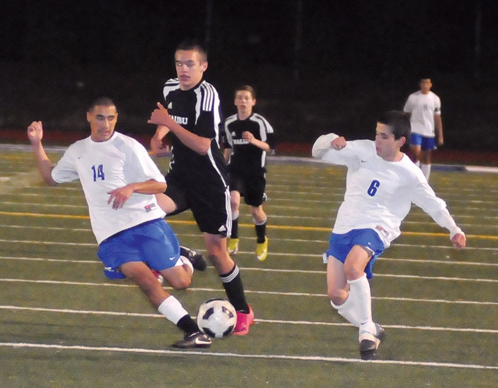 Bryan Ayala #14 and Jose Garcia #8 work together to keep the ball away from Malibu.