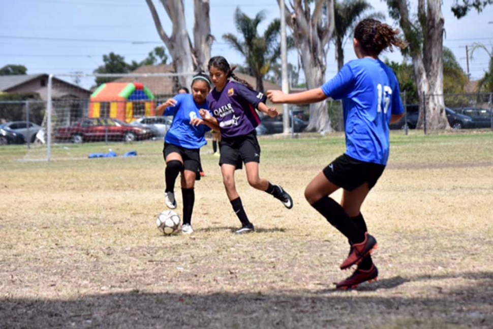 Two of our tireless mid-fielders, Fatima Alvarado (left) using some fancy footwork to get around the defender as Athena Sanchez (right) gets in position to receive the pass. Photo by Martin Hernandez.