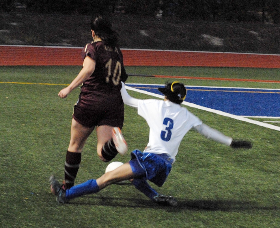Gaby Santa Rosa #3 tries to take the ball away from her opponent.