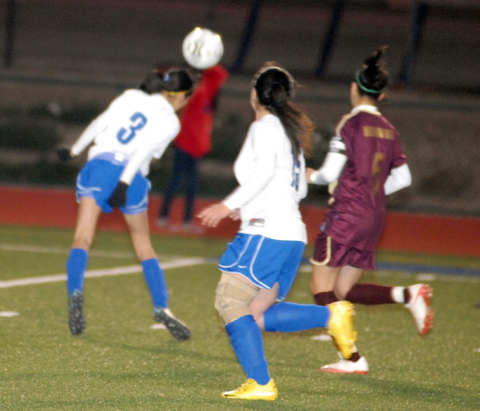 Gaby Santa Rosa #3 uses her head to move the ball on the field.