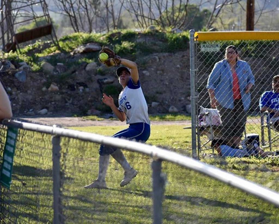 Senior Leah Meza makes a great catch in foul territory. Photo credit Betolu Photography.