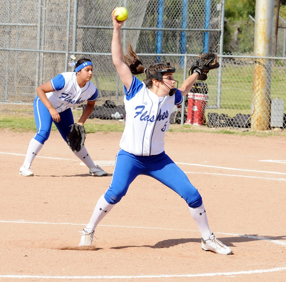 On the mound is #5 Miranda Faulkner and playing first base is #11 Mary Ortiz.