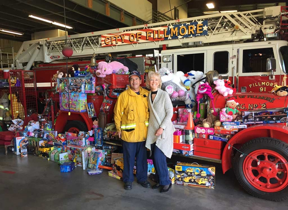 Fillmore Assistant Fire Chief Bill Herrera standing with Jane David who dropped off toys that the International Soroptimist of Fillmore collected from their Annual Fashion Show, Saturday, December 9th. Read more in Letters to the Editor on page 2. Photo courtesy Fillmore Soroptimist Club. Photo courtesy Jane David.