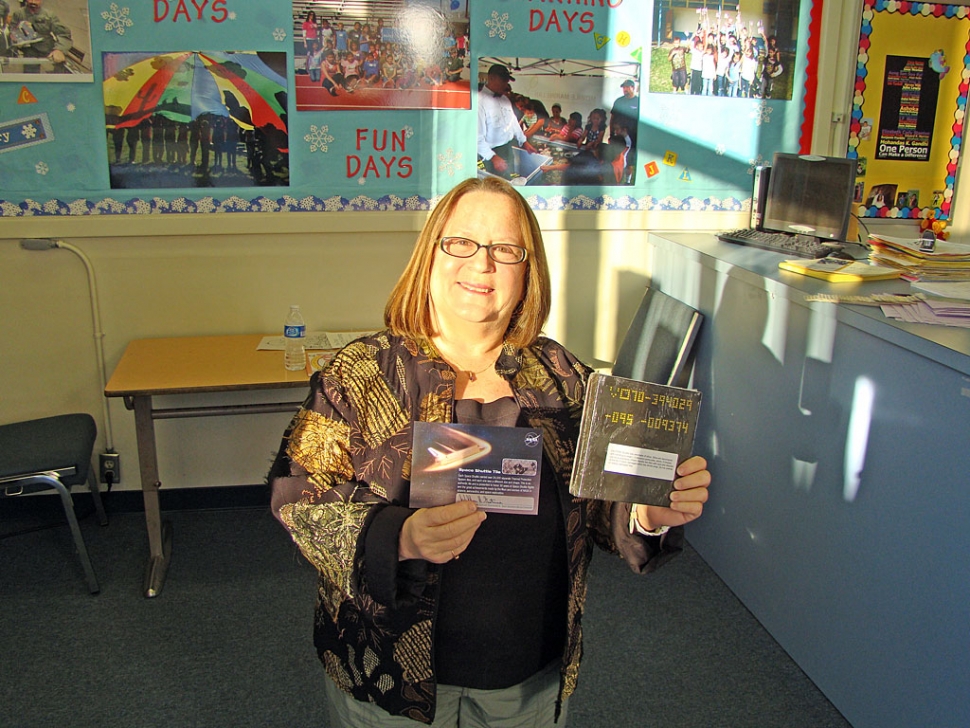 San Cayetano Principal Jan Marholin is holding an original Space Shuttle tile. With the sun setting of the Space Shuttle Program, NASA Explorer Schools were given the opportunity to acquire one tile. Each Space Shuttle carried over 24,000 Separate Thermal Protection System Tiles, and each one was a different size and shape. San Cayetano now has an original tile. It is encased in shrink wrap and cannot be undone. They are vey excited to add this artifact to their NASA Explorer School Program.