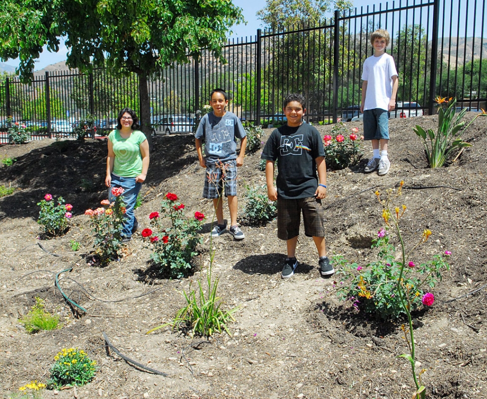 A beautiful Memorial Garden has been created by the teacher Laurie Merrill’s 3rd period class. Shown are just four of the students who participate in the garden project: (l-r) Silver Perez, Isaiah Martinez, Isaiah Mendez, and Justin Beach, who is working on a video of the project.