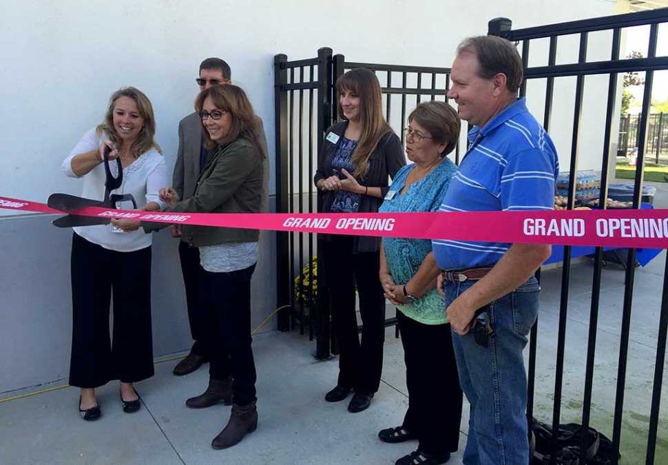 Cutting the Grand Opening ribbon with Ms. De La Piedra is the new Preschool Director Holly Harvan.