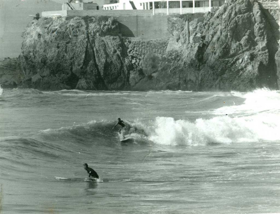 Surfers underneath the Cliff House, San Francisco. Photo credit: Fred Windisch