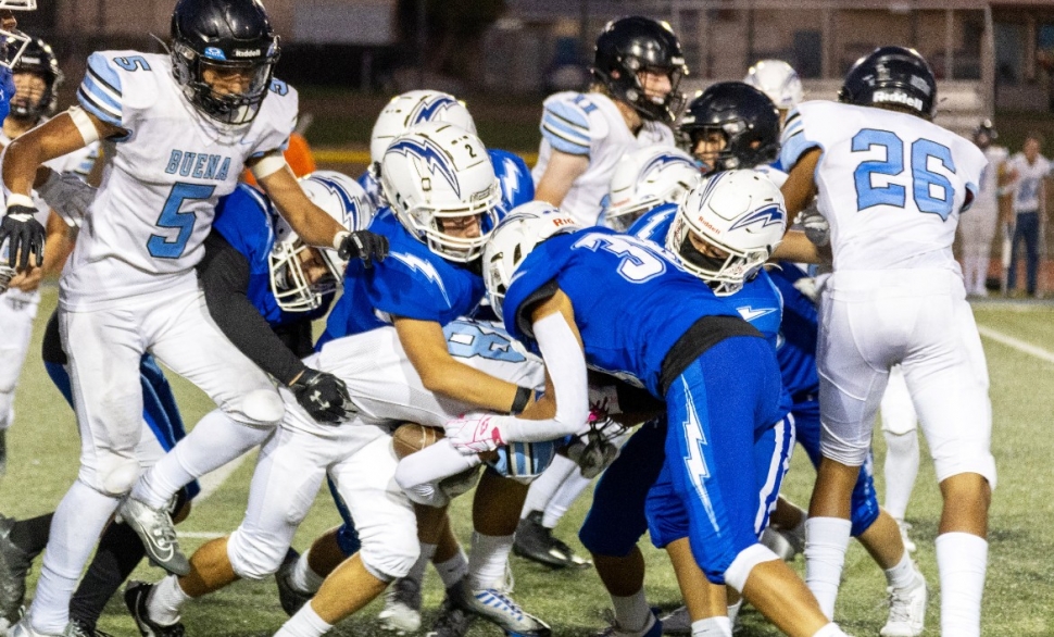 Pictured above is a group of Flashes taking down a Buena player to keep him from advancing up field. Inset, Flashes JV’s #2, making his way into the end zone, scoring a touchdown for the Flashes. Photo credit Crystal Gurrola. 