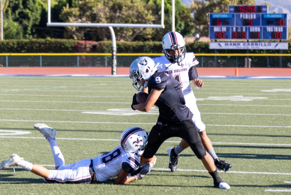 Pictured is Fillmore Raiders Junior #9 trying to get free from a Saints player and gain some yards for the team in last Saturday’s game. Photo credit Crystal Gurrola