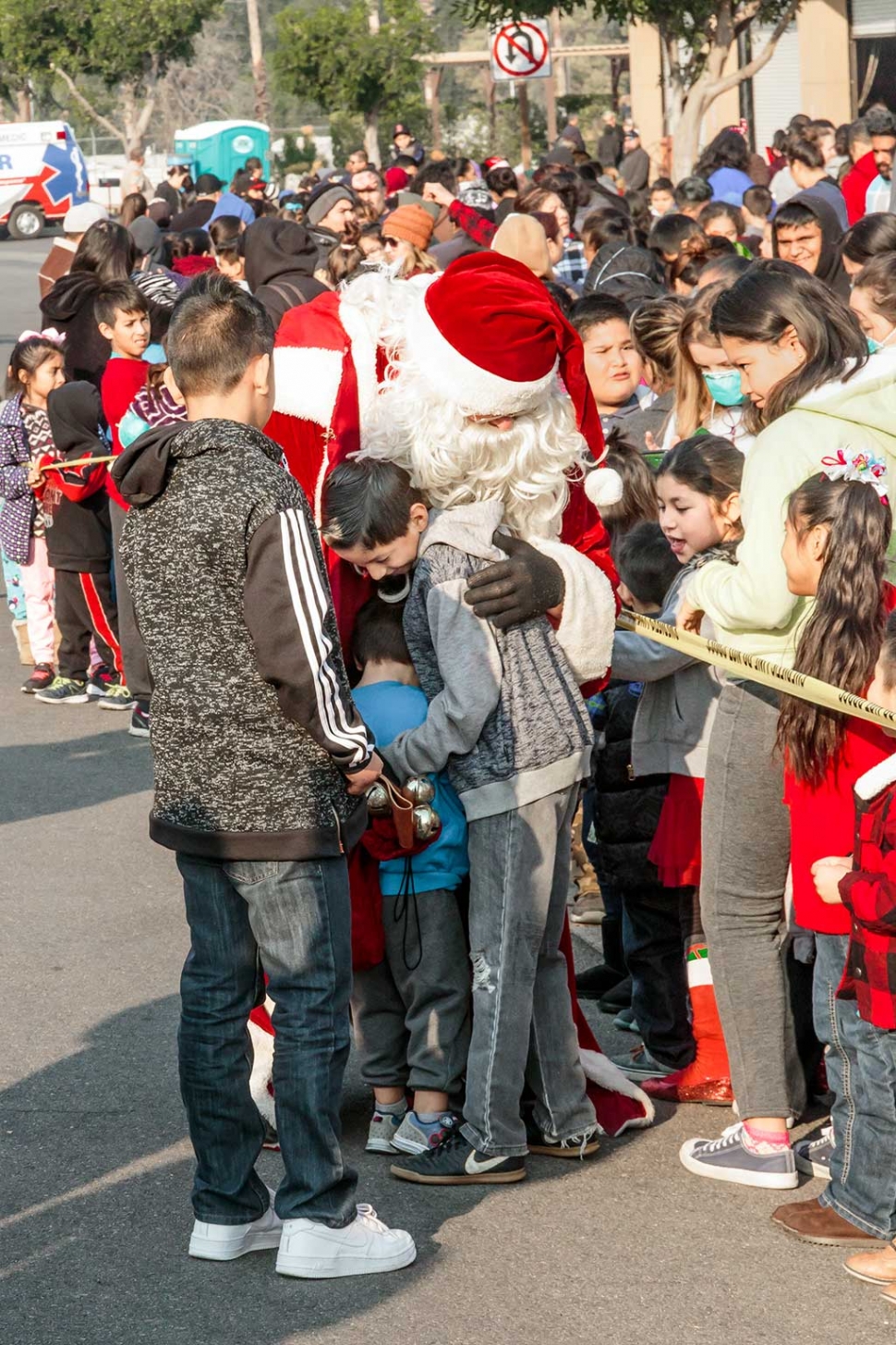 Santa Claus arrived right on time for the Fillmore Fire Departments Annual Toy Giveaway, held this past Saturday, December 17th at the Fillmore Fire Station. He arrived in style on Fire Engine 91, and waved to the waiting crowds before the hugs began. Also at the Toy Giveaway was the Santa Clara Valley Legal Aid’s Coats giveaway. Toy Giveaway photos courtesy Bob Crum.