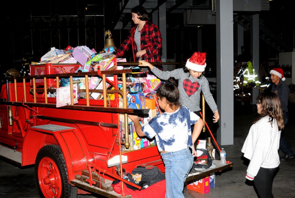 Above are some of the toys that were collected from last year’s Holiday Toy Drive with Santa’s helpers loading up the truck.