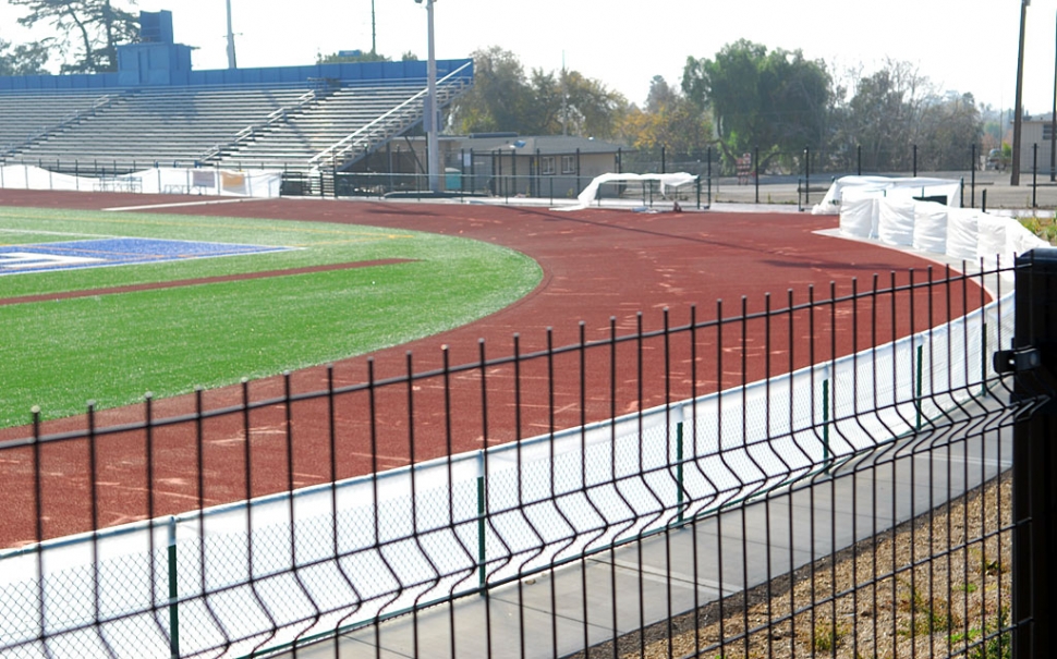 According to Bob Sube, who supervises Fillmore School District structure development, the high school track is undergoing significant corrective surgery. The all-weather track, which is composed of several layers of rubber particulate and a clear synthetic over-sheet sprayed with grit for traction, was not level. The lower spots collected water and made the surface less suitable for runners. This was the second major flaw discovered by Bob Sube. The first problem was related to sub-standard artificial turf. The entire playing field had to be removed and replaced. The cost was covered by warranties in the construction contract, as was the cost of leveling the track. The final coating for the track should be finished this weekend. The total cost of these corrections is estimated to be near $200,000. Mr. Sube has done an exceptional job of overseeing the District’s new construction. The Gazette recently found him checking-out Sespe School’s new playground equipment on his day off. He saw to it that a proper border was poured and a soft layer of material was placed under the equipment before it was put into use. This playground is avidly used by children from kindergarten through second grade.
