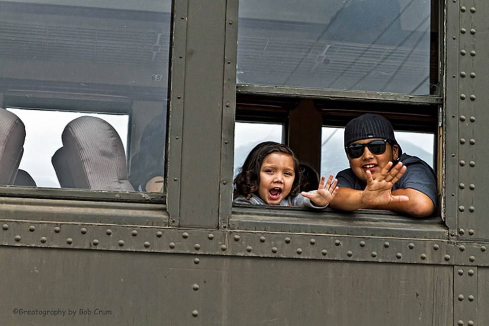 (above) A couple of Father’s Day train riders enjoy waving at the camera on Sunday. Some things are impossible. Like winning the lotto without buying a ticket and buying a ticket to ride the Dad's Day Express and not have a 'funtastic' ride. The Black Beauty of Fillmore & Western's locomotive fleet – the recently rebuilt Baldwin steam locomotive #14 – proudly huffed and chugged pulling a train of nine cars from Central Station to the Loose Caboose near Santa Paula. Imagine the nostalgic treat while observing the awesome scenery of the fabulous Santa Clara Valley. Listen... and you hear uncountable aaaaaaaahs. The 11 AM train ran under overcast skies and cooler temperatures but of no consequence considering the smiley faces of everybody filling all the seats... inside and out. Bright sunny skies guided the 3 PM train and everybody's smiles equaled the brightness of the sun. I wasn't fooled. Considering the fun had by all aboard... this was obviously a party train... in disguise. Story and photos by Bob Crum