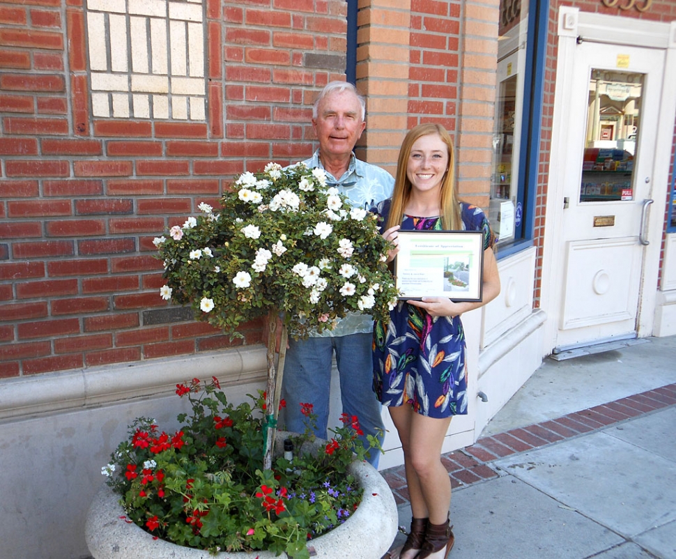 Civic Pride Committee member, Bill Dewey, presents a certificate of appreciation to his granddaughter, Kennedy Smith for her sponsorship of a Central Avenue refurbished planter.