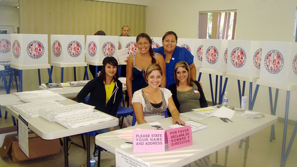 Voter turnout was fair Tuesday at St. Francis’ polling place. At 6pm, the voter count was approximately 200, not including absentee ballots. Poll workers pictured (l-r) are Samara Acosta, Monserrat Ayala-Montlongo and Liz Lopez; seated right is Niza Ayala-Quenta, and Ruth Ayala-Guzman.