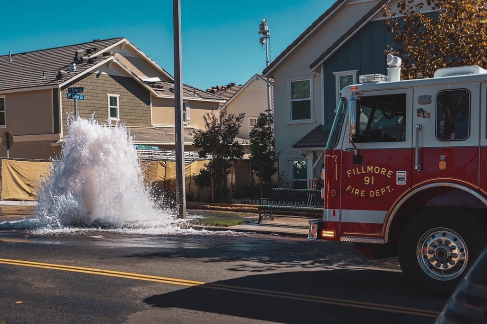 On Wednesday, October 19th, 2022, Fillmore Fire Department and AMR Paramedics were dispatched to a reported heavy traffic collision at River Street and Lemon Lane, Fillmore. Instead of a TC, firefighters found a gushing fire hydrant, apparently caused by an errant forklift operator. Firefighters were able to shut down the hydrant before it caused too much damage, no injuries were reported. Public works remained on scene, and the forklift operator went somewhere to dry out. Photo credit Angel Esquivel-AE News.