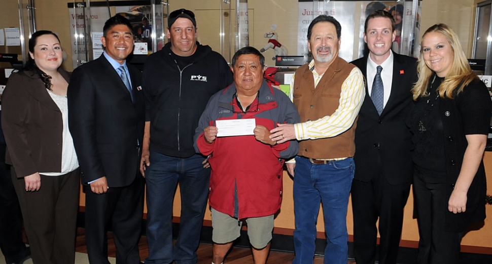 Wells Fargo Vons Fillmore Customer Service Manager Jimena Sanchez-Martinez (far left), Wells Fargo Vons Fillmore Store Manager Eric Irie (second from left); Wells Fargo District Manager Joe Ravens (second from right); and Wells Fargo Customer Service Manager Nyla Scott, present a $1,000 check to Piru Youth Sports representatives Fernando Vancini (third from left), Jim Sanchez (center), and Gill Escoto (third from right).