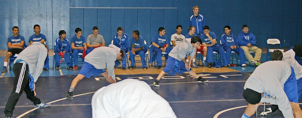 Fillmore warms up on the mat with Faith Baptist in the background.