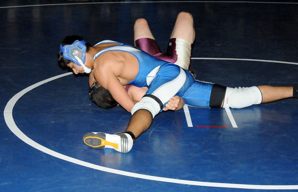 Kyle Castaneda attempts to pin his opponent during Tuesday night’s match.