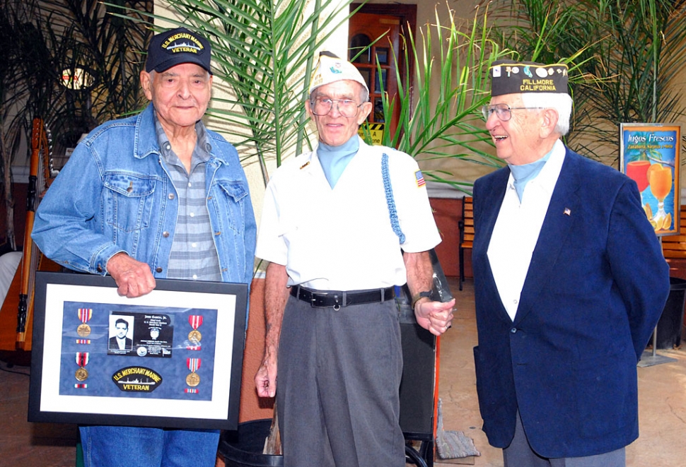 Shown (l-r) are John Garcia with a replica plaque, Dick Schuck and Bud Untiedt, all three veterans of World War II.
