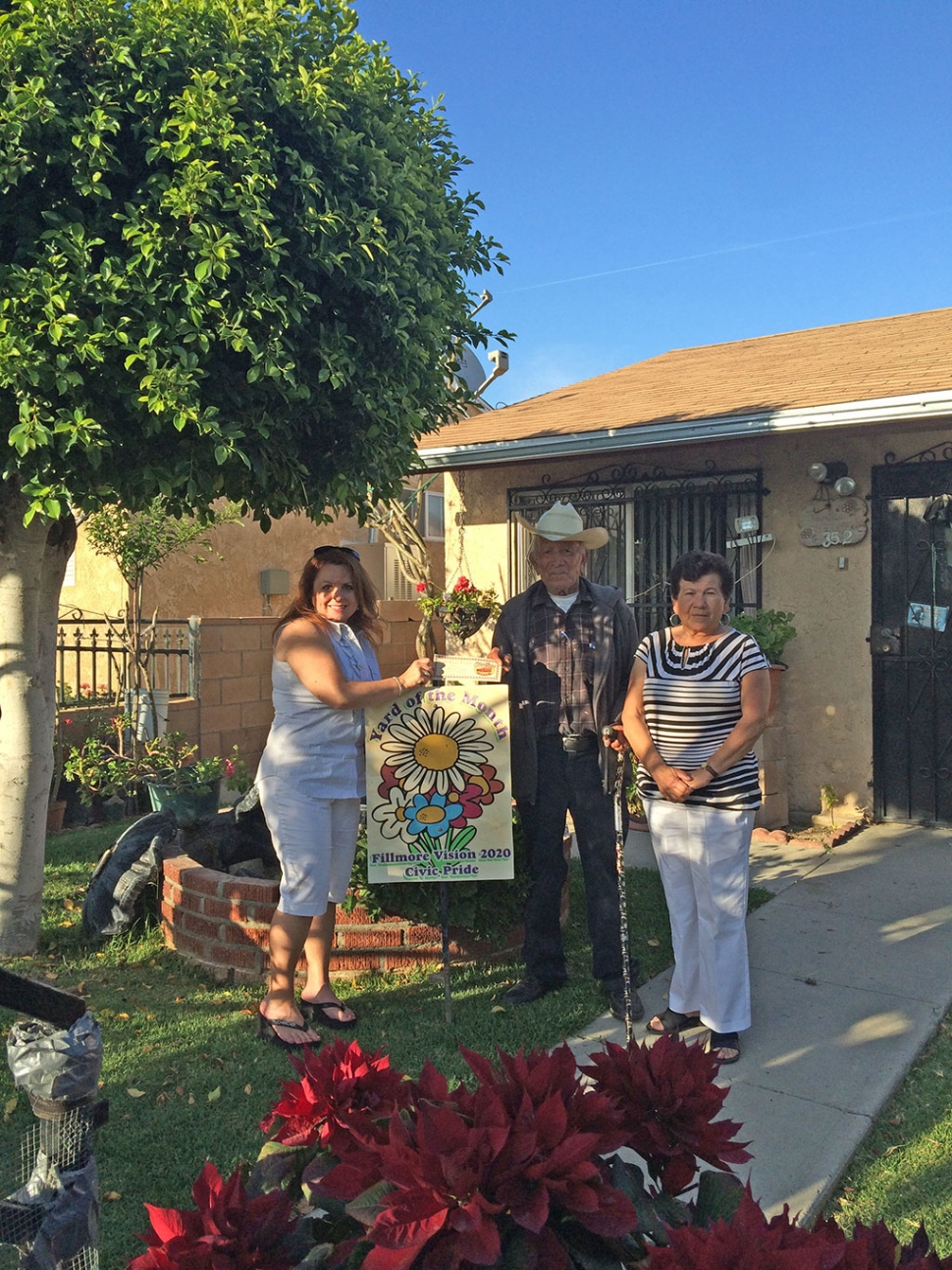 Theresa Robledo, assisting with the presentation of Fillmore Vision 2020 Civic Pride’s Yard of the Month for May awarded to Mr. Barajas (photo with his daughter, Margarita) Congratulations! Please drive by their yard located at 352 Mountain View, you will find beautiful variations of Geraniums, Pointsettias, lovely trees, and rose bushes all maintained by Mr. Barajas. When Mr. Barajas was describing why there were no roses on his rose bushes, he mentioned that his wife recently passed away and he cut them all to take them to her gravesite…holding back the tears, I was honored to present him with this recognition. A Big Thank you to Otto & Sons Nursery for providing a gift certificate to Mr. Barajas, where he will find more to add to his lovely garden!