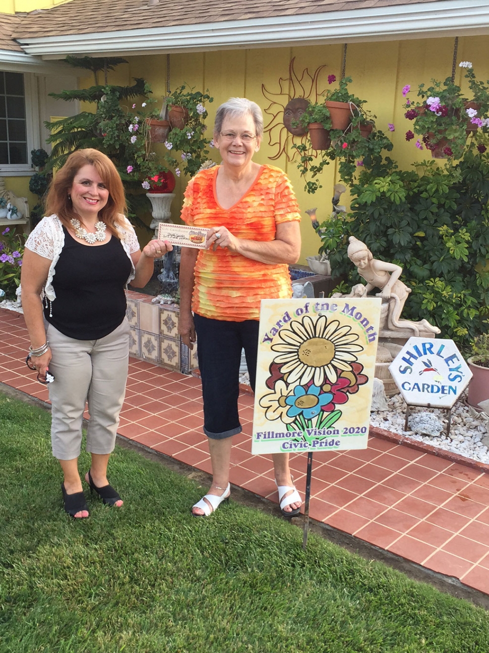 Theresa Robledo with Civic Pride Vision 2020 presents Yard of the Month to Shirley Spitler! Congratulations!  Please drive by 850 Oliver Street to view her gorgeous yard!  You will find at Shirley's home, roses, Christmas cactus, a lot of geraniums, succulents, and many beautiful garden statues. When I asked Shirley what inspires her to garden, she said, about 10 years ago her late husband, Bud Spitler, said do you want to trade grocery shopping for gardening?  Obviously, Shirley accepted and has been gardening ever since! Thank you to Otto & Sons Nursery for their generous gift certificate, where she will enjoy finding more items for her yard!