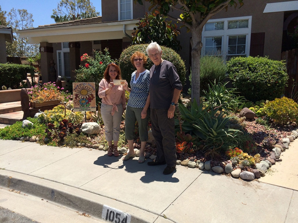 Theresa Robledo presents the Fillmore Vision 2020 Civic Pride’s Yard of the Month for July to Mr. and Mrs. Fitzgerald
