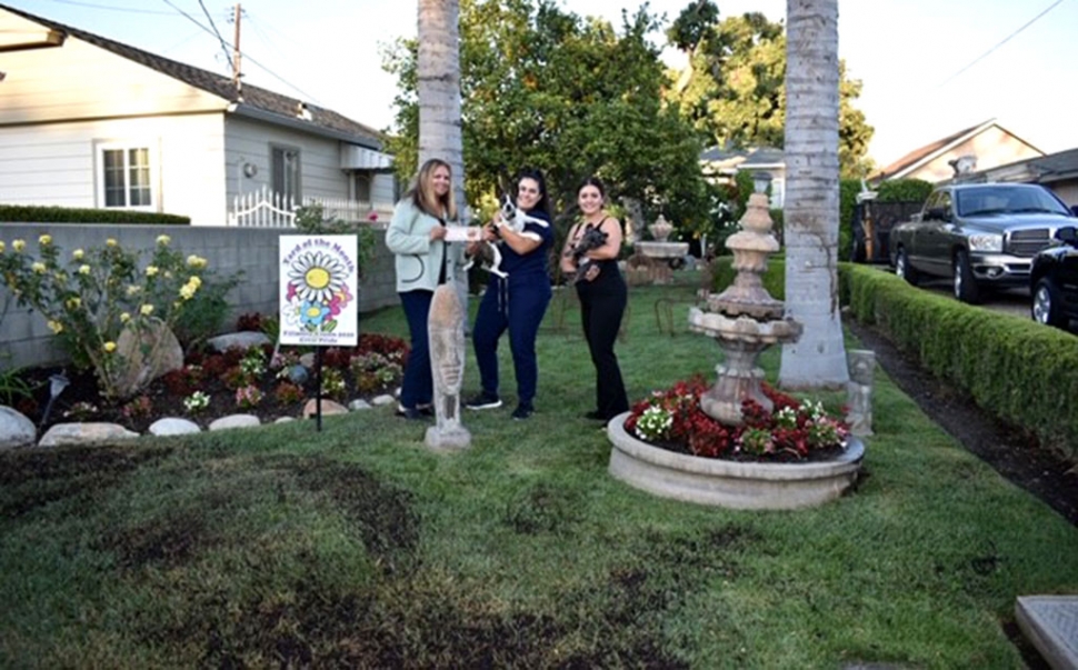 Fillmore Civic Pride/Vision 2020 announced their May 2019 Yard of the Month winner. Pictured left to right is Fillmore Civic Pride/Vision 2020’s Ari Larson presenting Kassandra Quintero (holding Rocky) and friend Maria Felix (holding Riley). Photo Credit Nancy Alonzo.