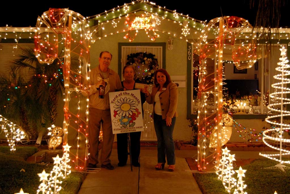 Theresa Robledo (right) presenting the Fillmore Vision 2020 Civic Pride December 2016 “Yard of the Month” award to Mr. & Mrs. Melgoza, along with a gift certificate from Otto & Sons Nursery. Congratulations to Mr. and Mrs. Melgoza at 360 C Street, their lovely Christmas Décor lights up the corner of C Street and Sespe!  Please drive by and view for yourself, the Melgozas have been decorating their home for many years, and we were invited inside their home to view all the beautiful décor of their Christmas Village!  The Melgozas were awarded a gift certificate from Otto & Sons for $40 and a bottle of wine from the Robledo Family Winery and Diamond Realty.  What Christmas cheer this home brings to our community and we thank our community that participate every year!   Fillmore Vision 2020 Civic Pride would also, like to make known honorable mentions: Edgewood and Taylor Lane, there are so many more in our community, feel free to take the family out for a tour in the evening to usher in the Christmas spirit!