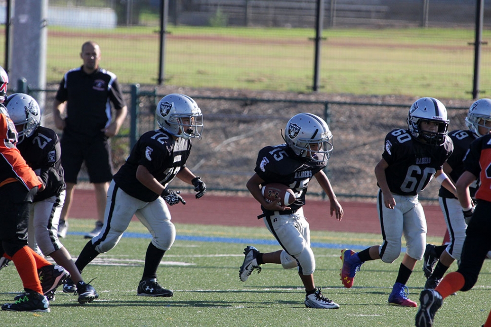 Raiders Bantam 15 runs for a first down. Photos courtesy Crystal Gurrola.