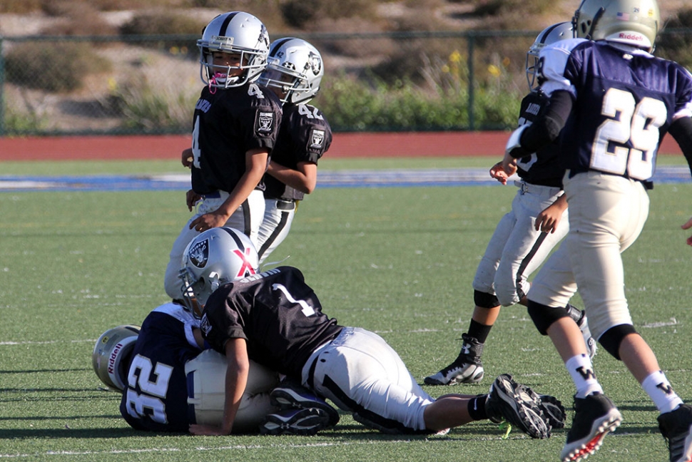 Raiders Bantam Black #1 makes a tackle