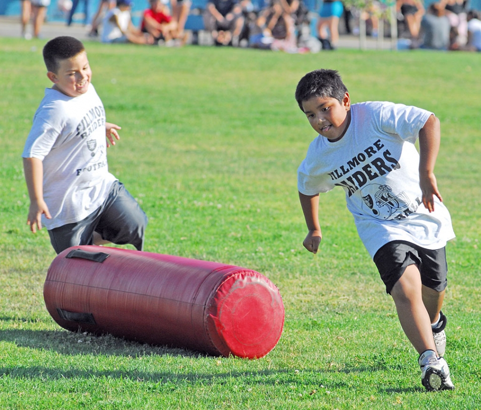 Above Raider football players run around the cushions.